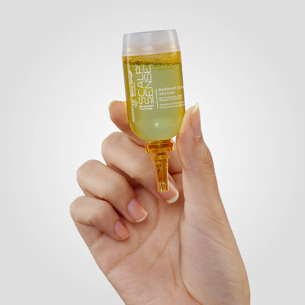 ScalpSense Dandruff Defense Vaccine" rests upside-down on a white surface against a gray background.